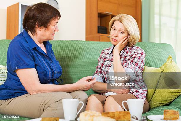 Two Female Having Serious Conversation Stock Photo - Download Image Now - Sadness, Family, Gossip