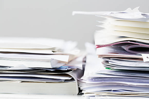 istock messy office desk stack of paper files and magazines 501060709