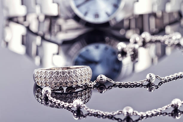 istock Silver ring and chain on the background of watches 501061420