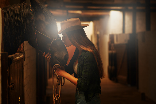 Shot of a young cowgirl standing in a stable with her horsehttp://195.154.178.81/DATA/i_collage/pi/shoots/783576.jpg