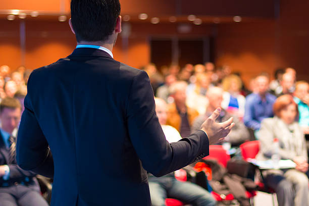 Speaker presenting at business seminar Speaker at Business Conference and Presentation. Audience at the conference hall. business conference stock pictures, royalty-free photos & images