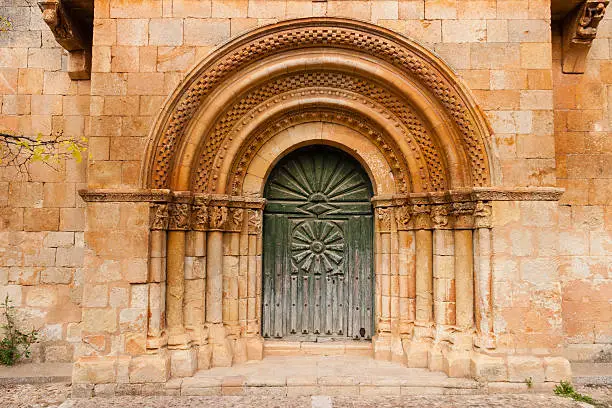 Romanesque portal with fine archivolts and beautiful door of the church in a small village called Moarves de Ojeda in the povince of Palencia  Spain