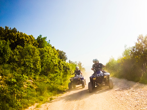 two guys on quad bikes on mountain trail