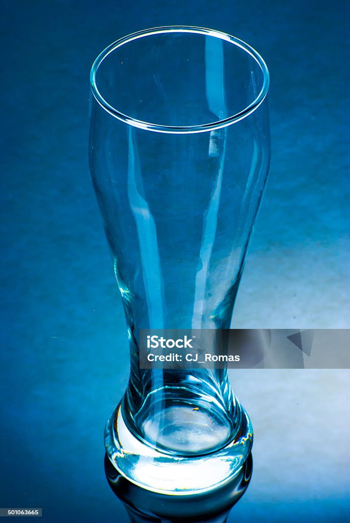 Empty glass on a reflective surface An empty glass on black reflective surface Alcohol - Drink Stock Photo