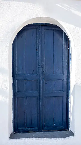 Photo of Blue door and white house in Santorini