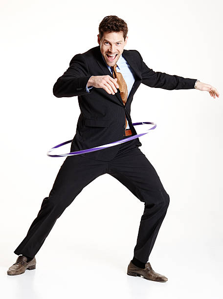 istock Happy businessman dancing with hula hoop 501064339