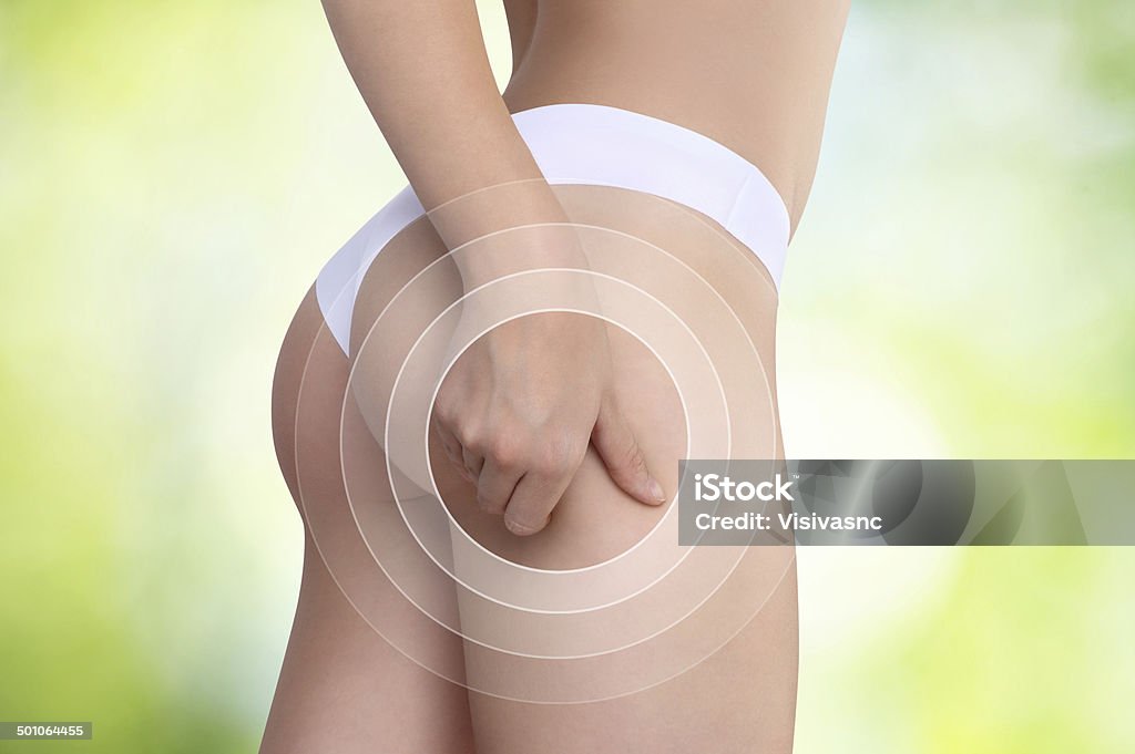 Woman pinches her thigh to control cellulite Adipose Cell Stock Photo