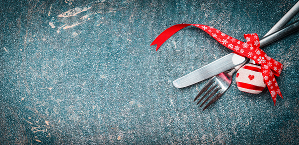 Christmas food background with table place setting: fork, knife and festive decoration, banner