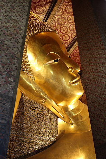 istock reclining buddha gold statue face at wat pho in bangkok 501071146