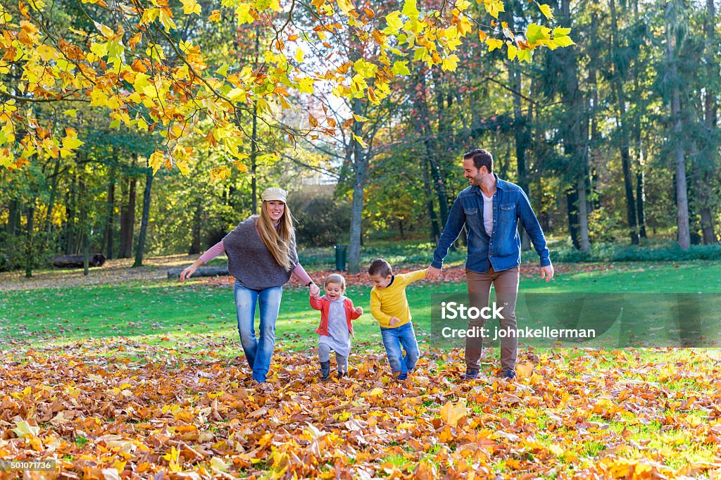 Family walking on leaves Active Lifestyle Stock Photo