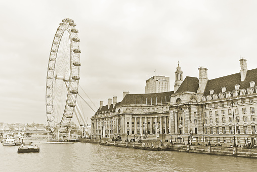 London, UK - December 31, 2014: View of the London Eye and the buildings next to River Thames in London on December 31, 2014. 