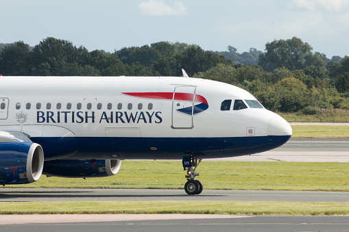 Manchester, United Kingdom - August 27, 2015: British Airways Airbus A320 (G-EUUY) taxiing on Manchester International Airport tarmac after landing.