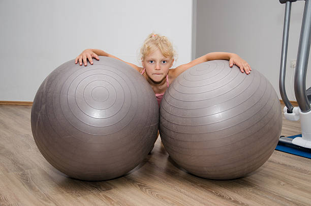 istock girl with two gym balls 501072978