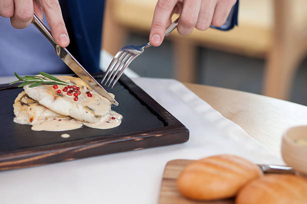 istock Rich young businessman is eating at cafe 501085788