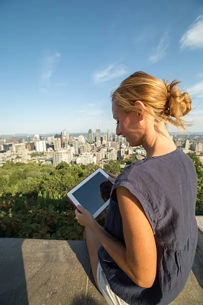 Photo of Young woman using digital tablet in Montreal