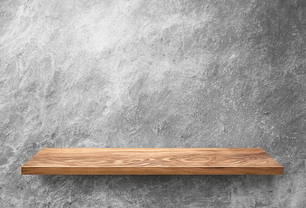 istock Wooden shelf on concrete wall 501088658