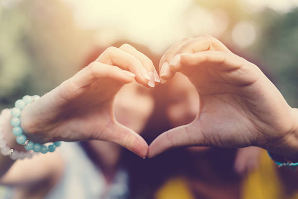 istock Mixed race girls making heart symbol with hands 501089484