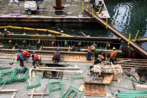 Chicago, USA - December 12, 2015: Construction workers working on a new section of the River Walk, South bank of the Chicago River, between LaSalle Street and Wells Street, downtown Chicago.