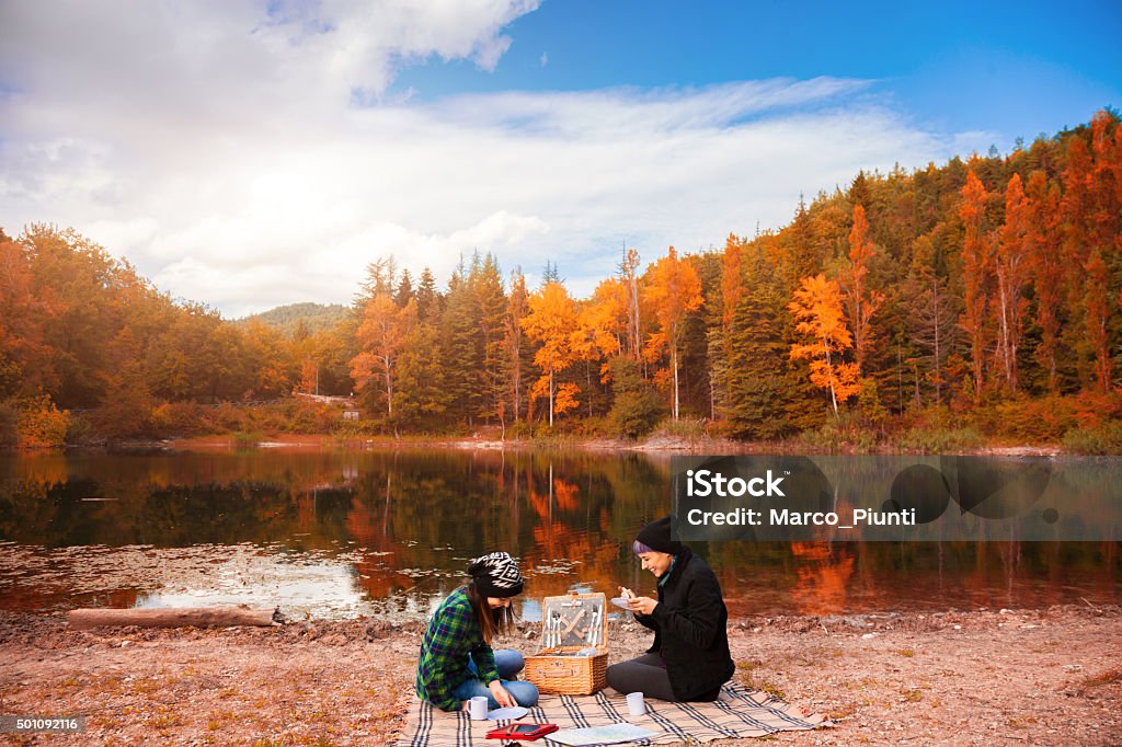 Two beautiful girl, relax in the mountain Two beautiful girl, relax in the mountain, play with tablet and drink some coffee Adventure Stock Photo