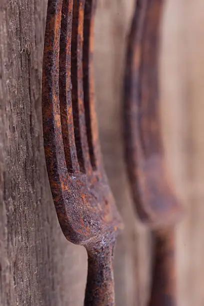 Photo of old rusty fork on a wooden Board closeup