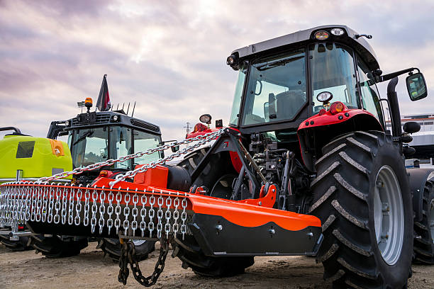 istock Red tractor equipped with bush cutter mounted on the back. 501094778