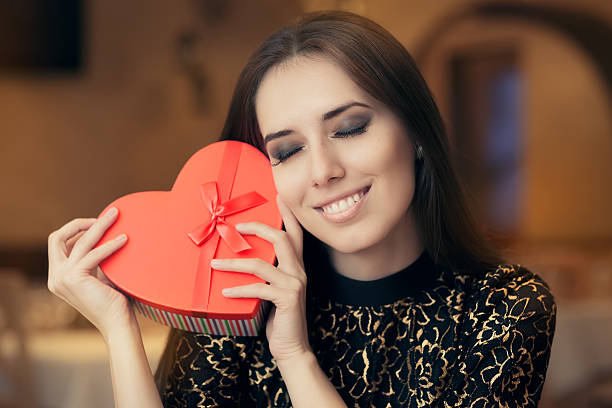 istock Beautiful Elegant  Woman Holding Heart Shape Gift 501097964