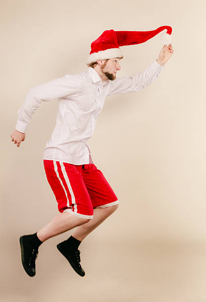 istock Active man in santa hat dancing and jumping. 501115584