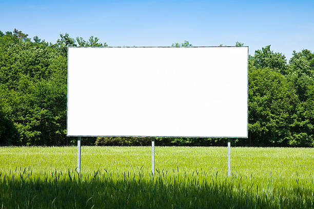 Blank advertising billboard A blank advertising billboard immersed in a wheat field roadside stock pictures, royalty-free photos & images