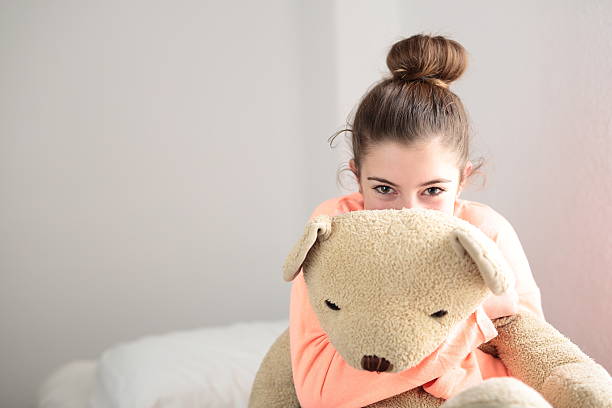 istock teen hugging her teddy 501117794