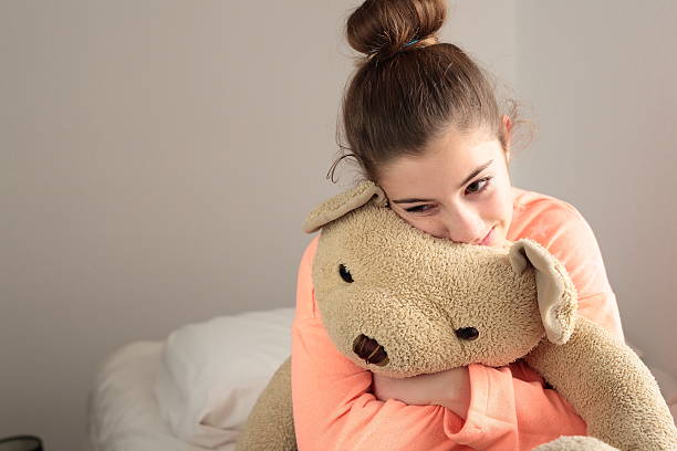 istock teen hugging her teddy 501117944