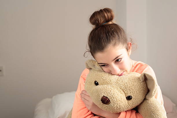 istock teen hugging her teddy 501117980