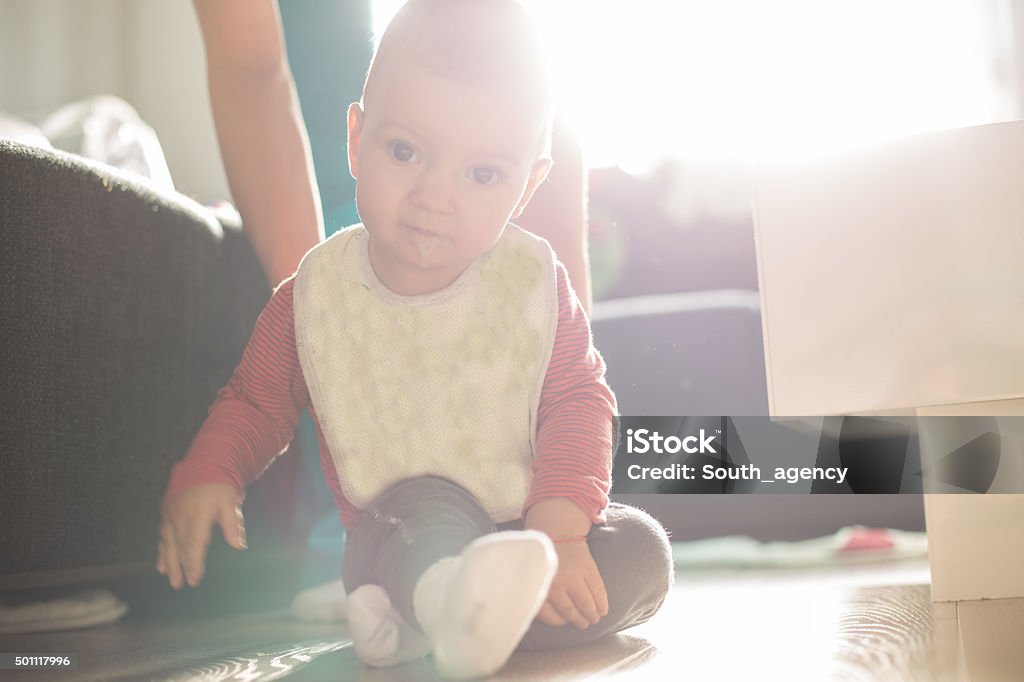 Small wonderer Morning sunlight coming through to light the baby. 12-17 Months Stock Photo
