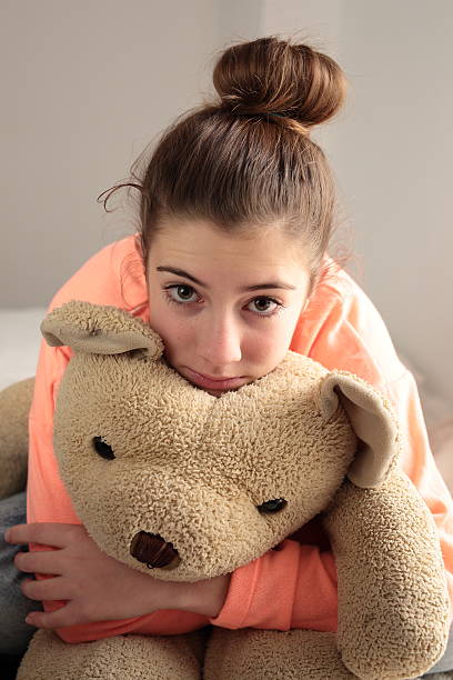 istock teen hugging her teddy 501118036