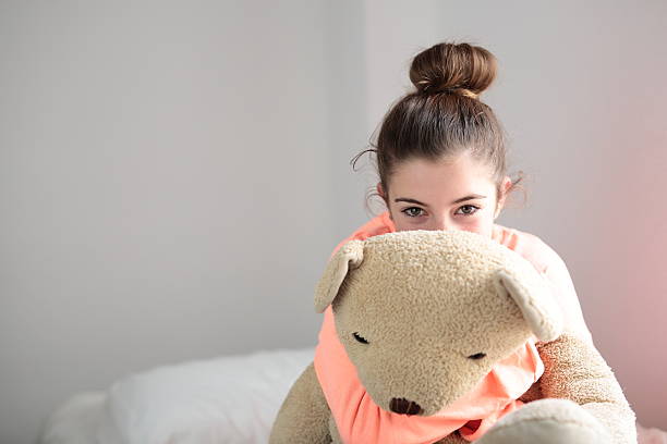istock teen hugging her teddy 501118088