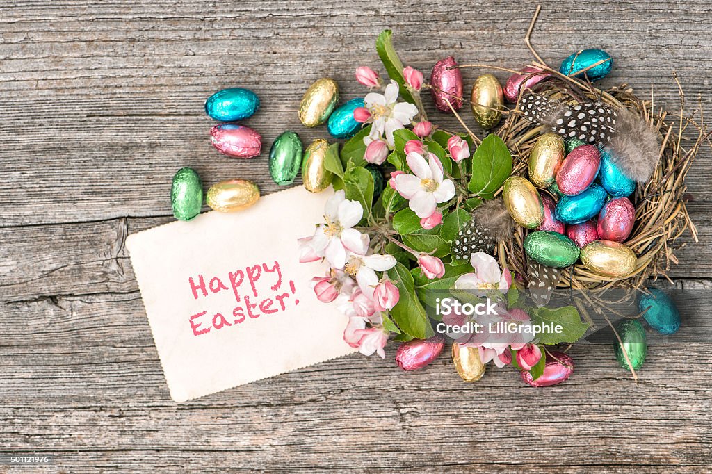 Chocolate easter eggs and apple tree blossoms. Spring flowers Chocolate easter eggs and apple tree blossoms on wooden background. Festive decoration with spring flowers and greetings card 2015 Stock Photo