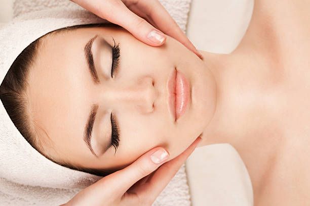 istock Young woman doing facial massage 501122074