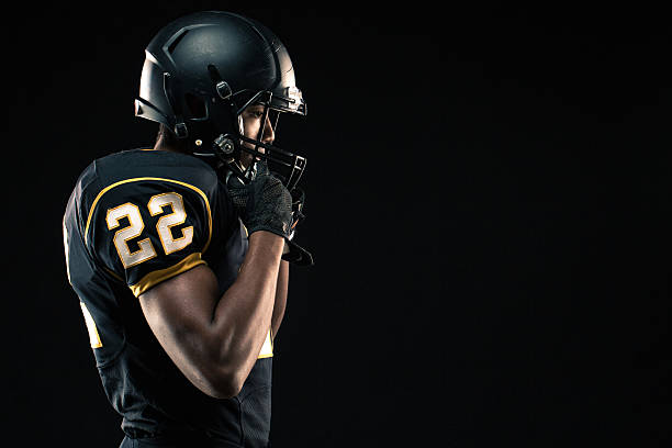 Football Player Young African American football player. sports uniform photos stock pictures, royalty-free photos & images