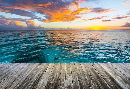 wooden deck at caribbean sea at sunset