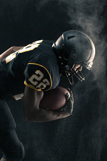 istock Football Player breaking through 501130796