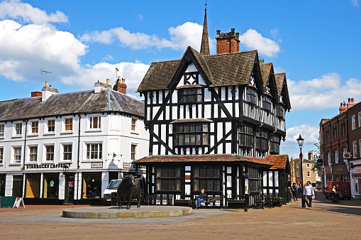 Hereford, United Kingdom - June 5, 2014:  The High House in High Town Built in 1621 with shoppers passing by, Hereford, Herefordshire, England, UK, Western Europe.  The building was once part of Butchers Row but is now the only one left standing.