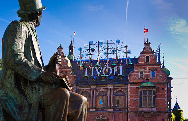 Tivoli Gardens Copenhagen Сopenhagen, Denmark - June 10, 2014: Tivoli Gardens Copenhagen, Denmark with the statue of poet H.C. Andersen in front. statue of hans christian andersen stock pictures, royalty-free photos & images