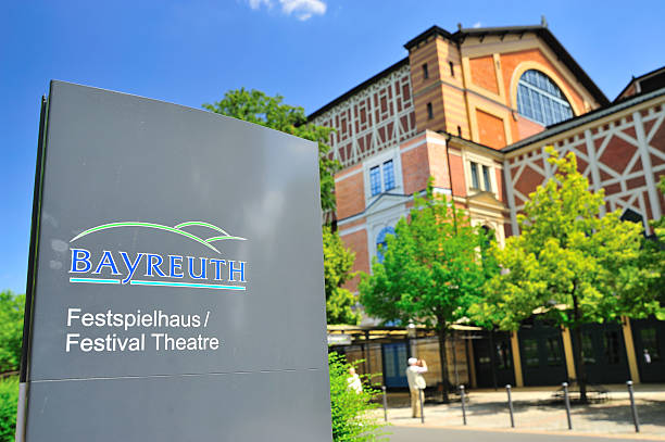 Festival Theatre Bayreuth, Bavaria, Germany - July 2, 2014: Sign of Festival Theatre in front. Visitor are making a photograph of the building. bayreuth stock pictures, royalty-free photos & images