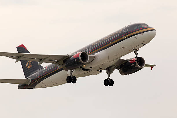 Departing Royal Jordanian Airbus A320-232 aircraft in the rainy day stock photo