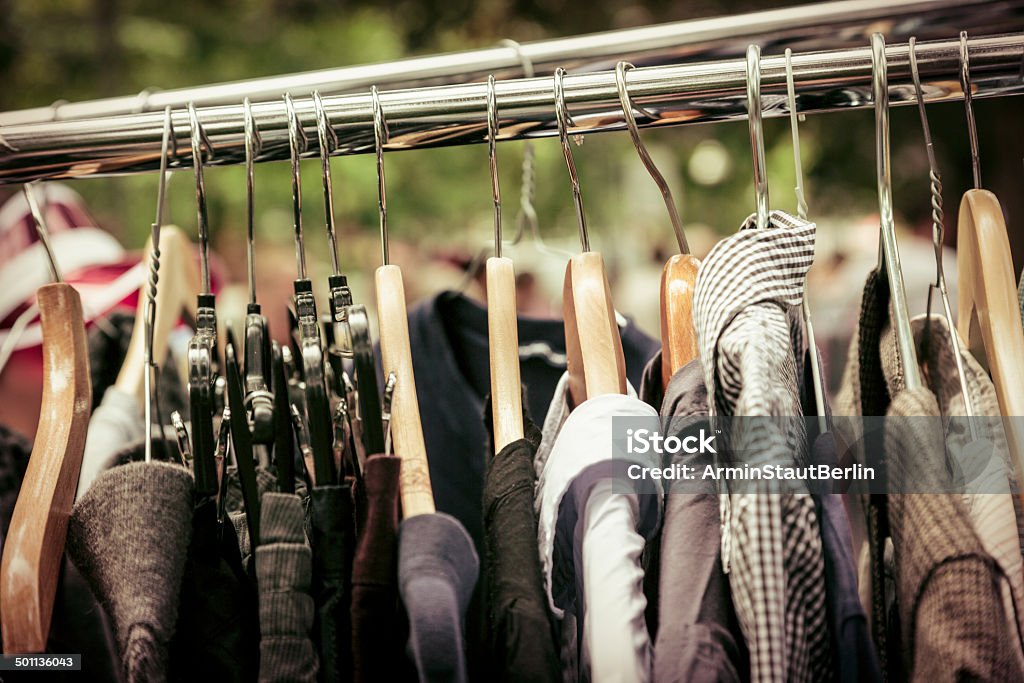 clothes on a rack on a flea market clothes on a rack on a flea market. Garage Sale Stock Photo