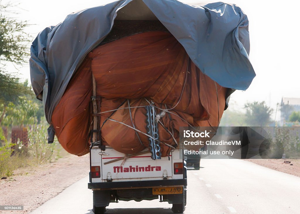 Mahindra pickup truck overloaded. Nagaur, India - February 12, 2011: Common practice of loading a pickup truck to the max and driving it on the road. Asia Stock Photo