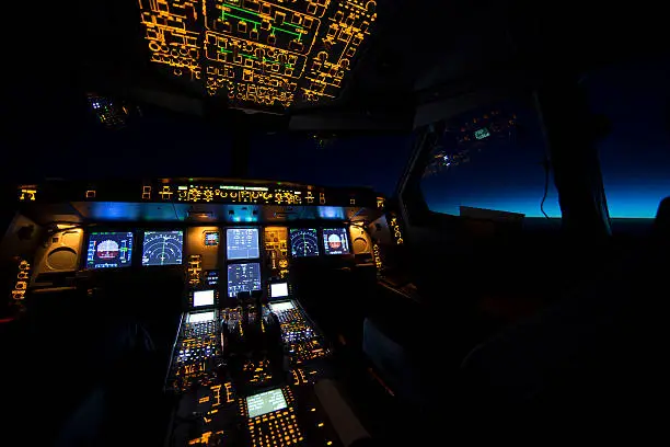 Cockpit of transport aircraft at sunrise or sunset