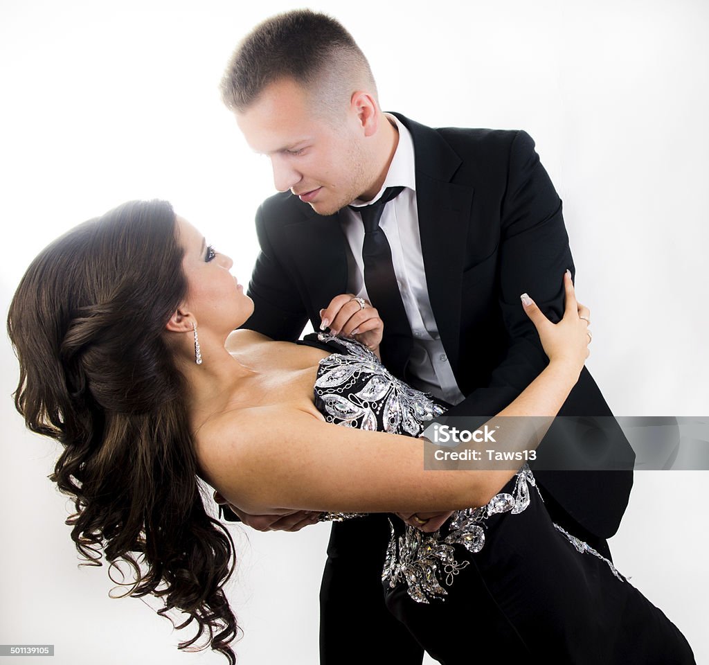 European young couple Portrait of young European couple in a photo studio wearing suit and luxury clothes. Couples were having their engagentment. white background, colour image. posing. Adult Stock Photo