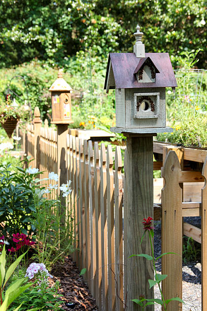 istock Birdhouse Sitting on a Post in a Garden 501139873