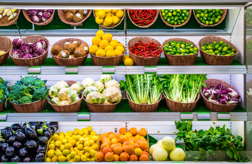 Fruits and vegetables on a supermarket shelf.