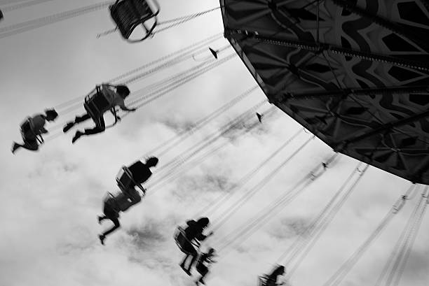 istock People swinging around on chair in a carnival 501145820